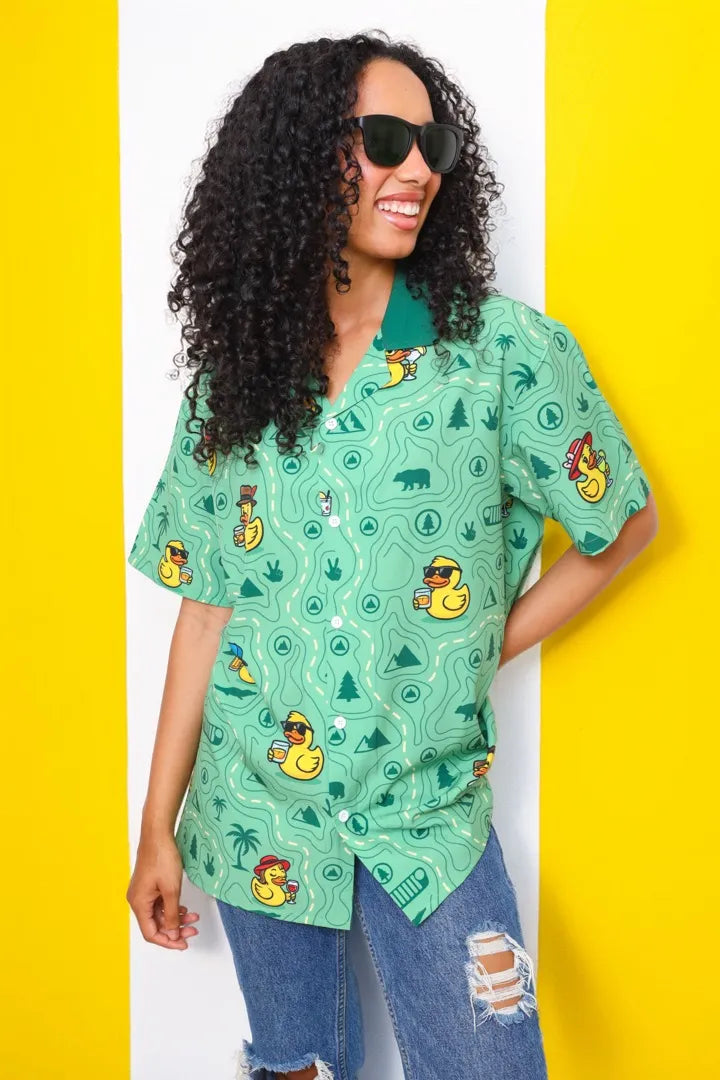 A woman in sunglasses in the Quack Rated shirt against yellow and white stripes